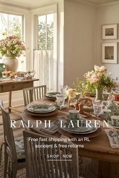 a dining room table with plates and flowers on it