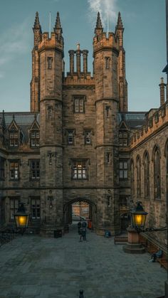 an old castle with two towers and lights