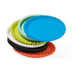 four plastic plates stacked on top of each other with different colors and shapes in them