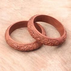 two wooden rings sitting on top of a table