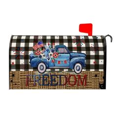 a mailbox cover with an old blue truck and american flag on the front,