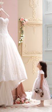 an ad for david tutera bridal collection, featuring a bride and her flower girl