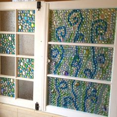 an old window is decorated with glass beads