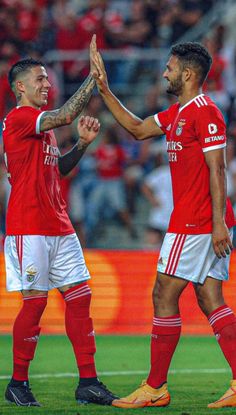 two soccer players giving each other high fives