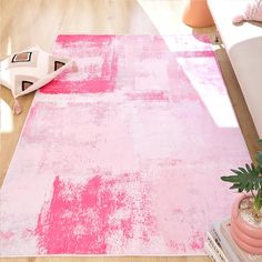 a pink rug on the floor in a living room