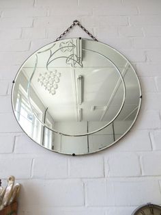 a mirror hanging on the wall next to a clock