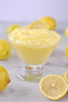 a bowl filled with lemon custard next to sliced lemons