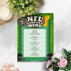 a football game day menu is shown on a table with flowers and other items around it