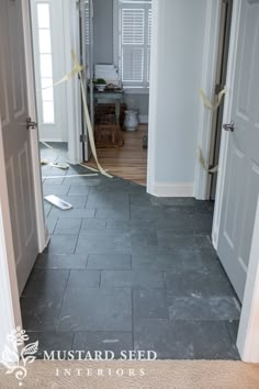 an open door leading into a room with white walls and wood trimmings on the floor