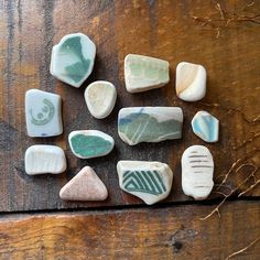 several different types of rocks sitting on top of a wooden table next to each other