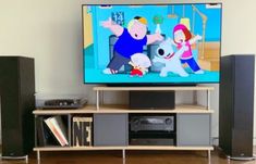 a flat screen tv sitting on top of a wooden entertainment center