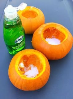 three peeled pumpkins sitting on top of a table next to a bottle of mouthwash