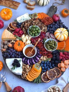 a platter filled with different types of fruits and veggies on top of a table