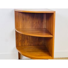 the corner shelf is made out of wood and has two shelves on each side,