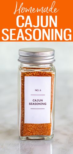 a jar filled with cajun seasoning sitting on top of a counter next to the words homemade cajun seasoning