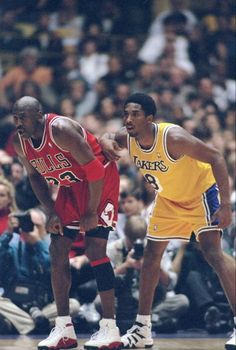 two basketball players standing next to each other