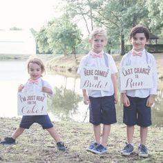 three young boys holding signs that say, here comes the bride and i am just here