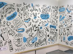 the wall is decorated with blue and white doodles