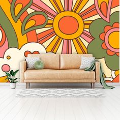 a couch sitting in front of a colorful wall mural