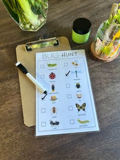 a clipboard with bugs on it next to some flowers and a vase filled with water