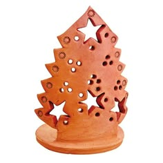 an orange wooden christmas tree with holes in the center and stars on it's sides