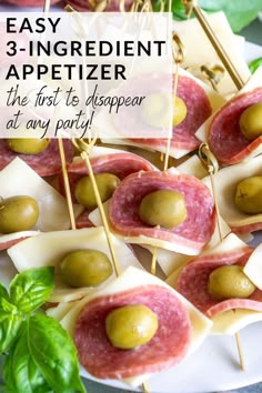 appetizers with olives and cheese on them are ready to be served at any party