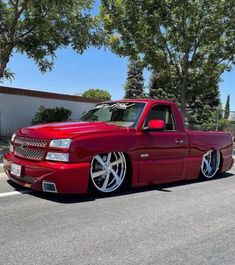 a red truck parked on the side of a road