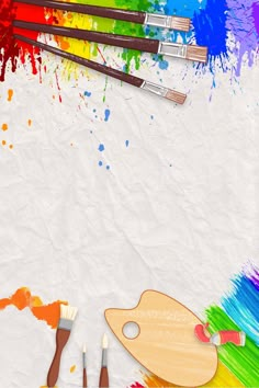 paintbrushes, palettes and other art supplies on white paper with rainbow colors