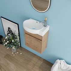 a bathroom with a sink and mirror on the wall next to a flower arrangement in a vase