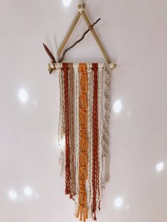 a wall hanging made out of wood sticks and rope