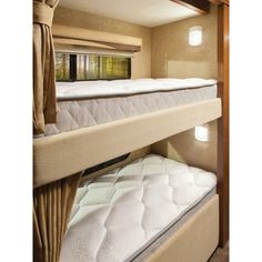 two bunk beds in a small room with curtains