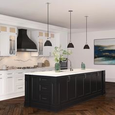 a large kitchen with white cabinets and black island