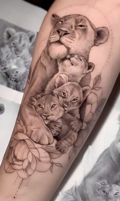 a woman's arm with an image of two lions and roses on the side