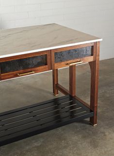 a wooden table with two drawers on one side and a metal shelf underneath the other