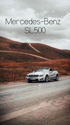 a mercedes benz sl 500 driving down a road with the words mercedes - benz sl 500 above it