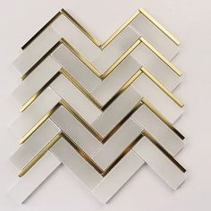 a white and gold herringbone tile pattern