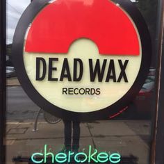 a sign that reads dead wax records in front of a store window with the word, checkee on it