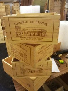 three wooden boxes stacked on top of each other in an office area with desks and chairs