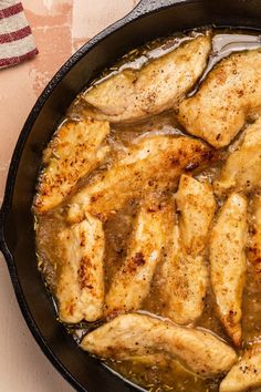 some chicken is cooking in a skillet on a table with an american flag napkin