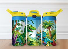 three children's water bottles with dinosaurs and trees on them, sitting on a wooden floor