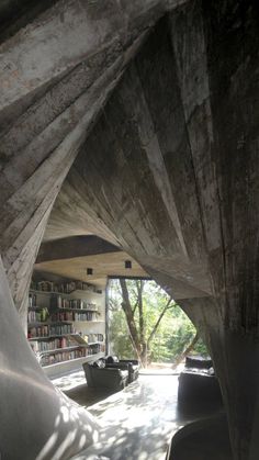 the inside of a house with bookshelves and couches