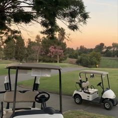 a golf cart parked on the side of a road in front of a green field