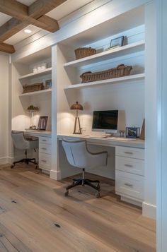 a home office with built - in desks and shelving on either side of the room