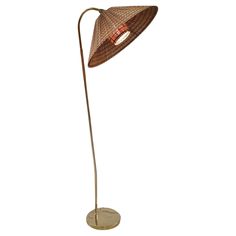 a floor lamp with a brown shade on the top and an orange light in the middle