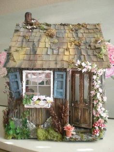 a doll house made out of clay and flowers