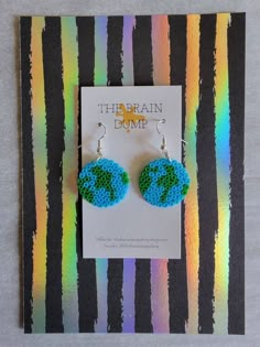 the brain dump earrings are made out of seed beads and have a green globe on it