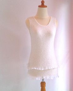 White Stretch Knit Top For Layering, White Ruffled Tops For Layering, White Crew Neck Knit Top For Layering, White Ruffled Knit Top For Spring, Fitted White Knit Top, White Knit Top For Summer Layering, Elegant White Knitted Top, White Knitted Top For Layering, White Sleeveless Knit Top