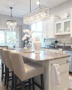 an instagram photo of a kitchen island with chairs