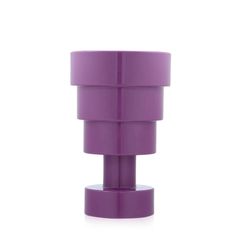 a purple vase sitting on top of a white table