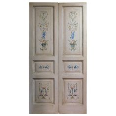 two white doors with floral designs painted on them